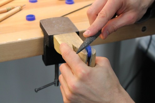 Using a flat file to carve a row of dragon scales