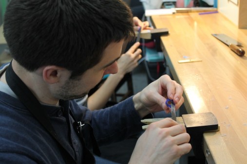 Greg resizing the ring by removing wax from inside