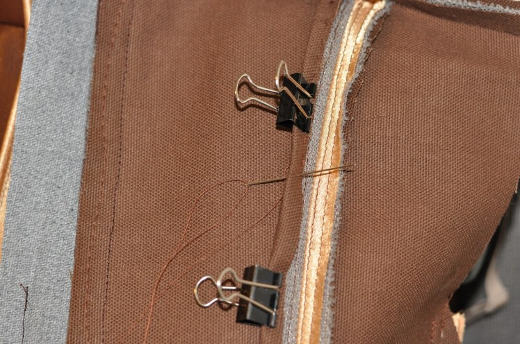 Finishing the seams with canvas bias tape to reduce discomfort of metal fabric. 