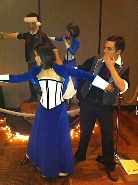 Elizabeth and Booker cosplayers posing with Bioshock Infinite statue at Child's Play 2013